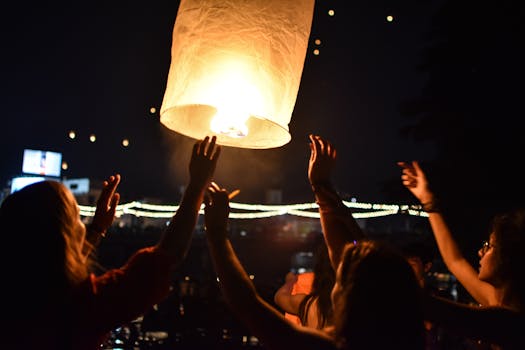 People celebrate by launching a sky lantern at night in Chiang Mai, Thailand.