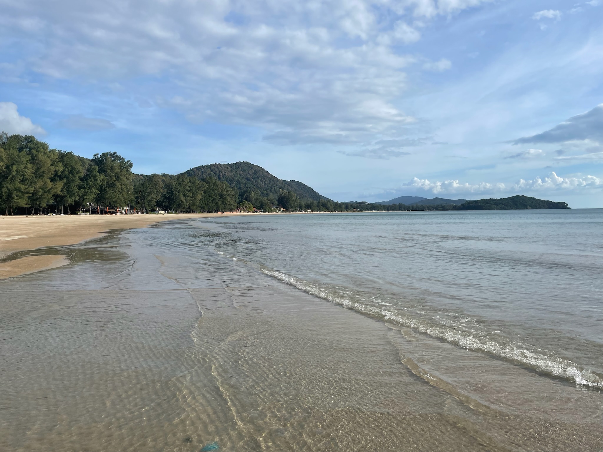 Beach with mountains in background in Koh Lanta