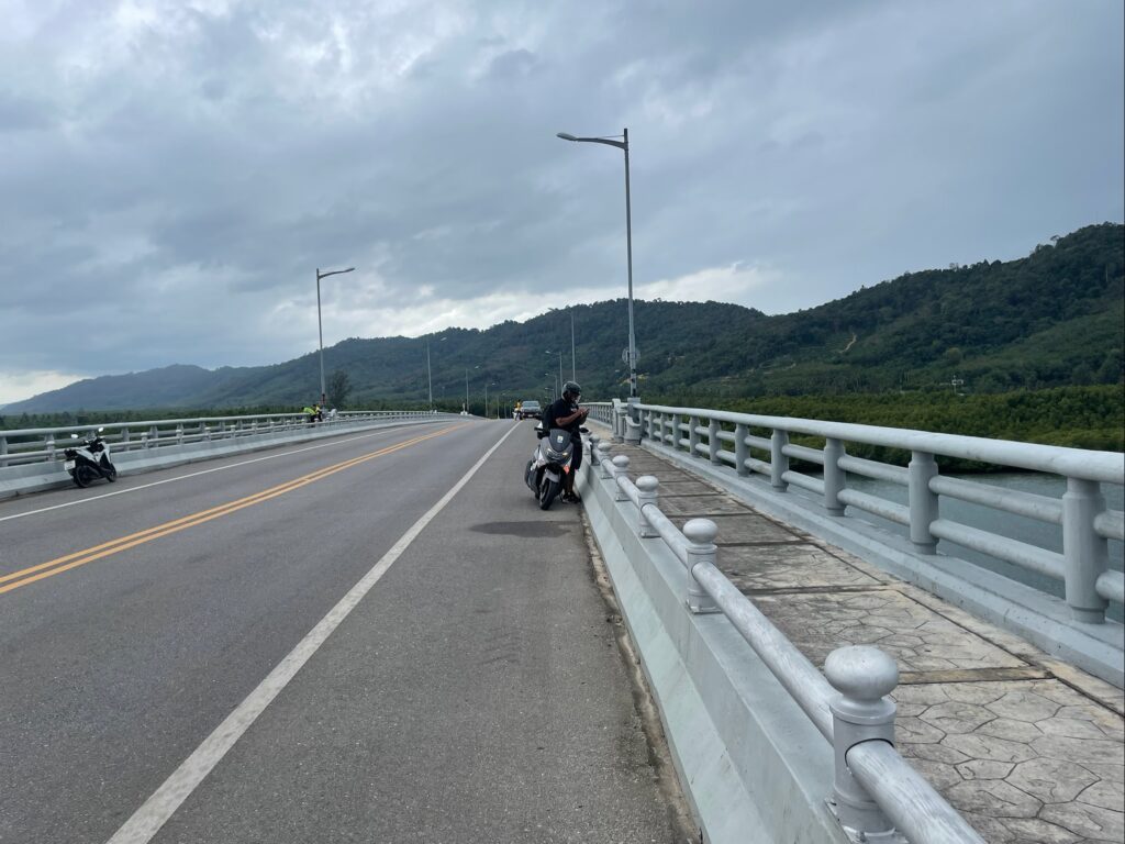 motorbike rider stopping on koh lanta bridge
