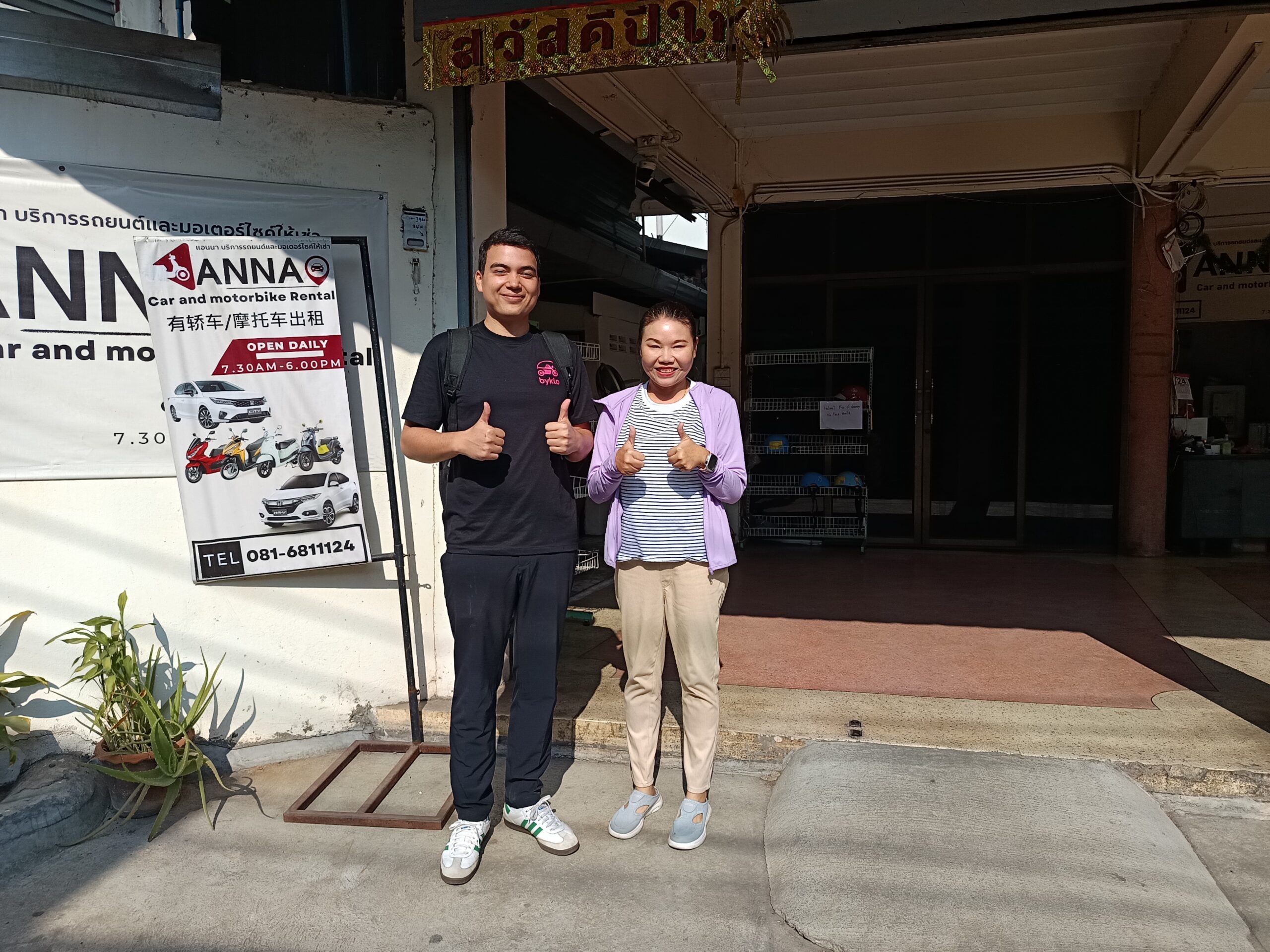 Byklo employee with owner outside of Anna Motorbike For Rent motorbike rental shop