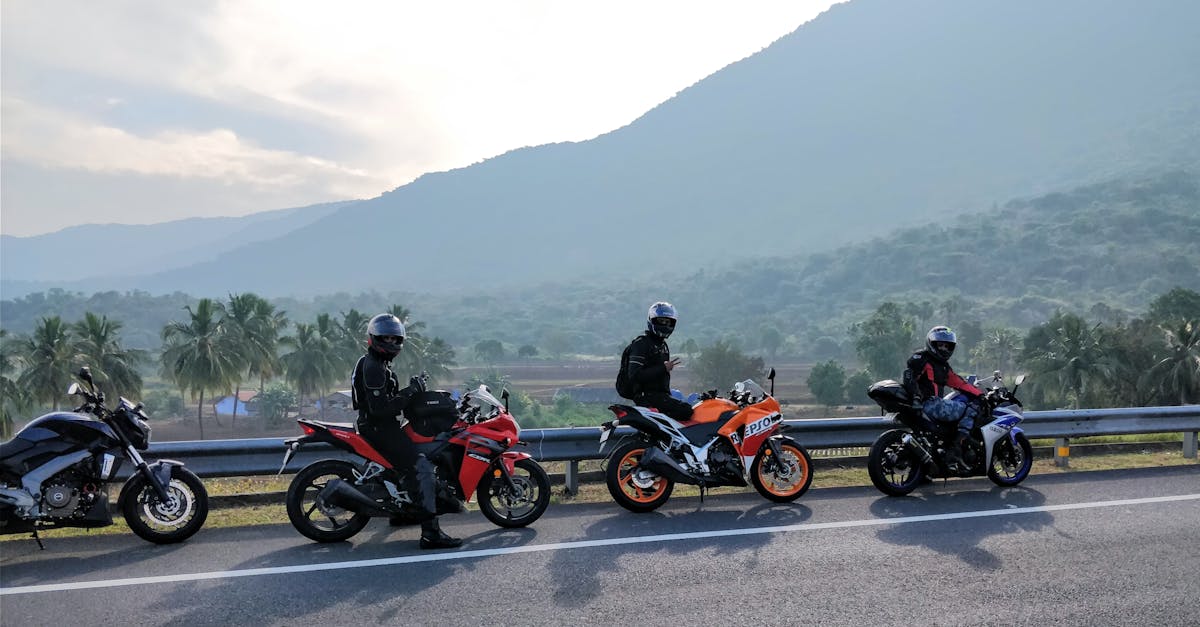 Top 10 Scenic Motorbike Routes Around Chiang Mai Three motorcyclists on a scenic mountain road with lush greenery in the background, enjoying a ride.