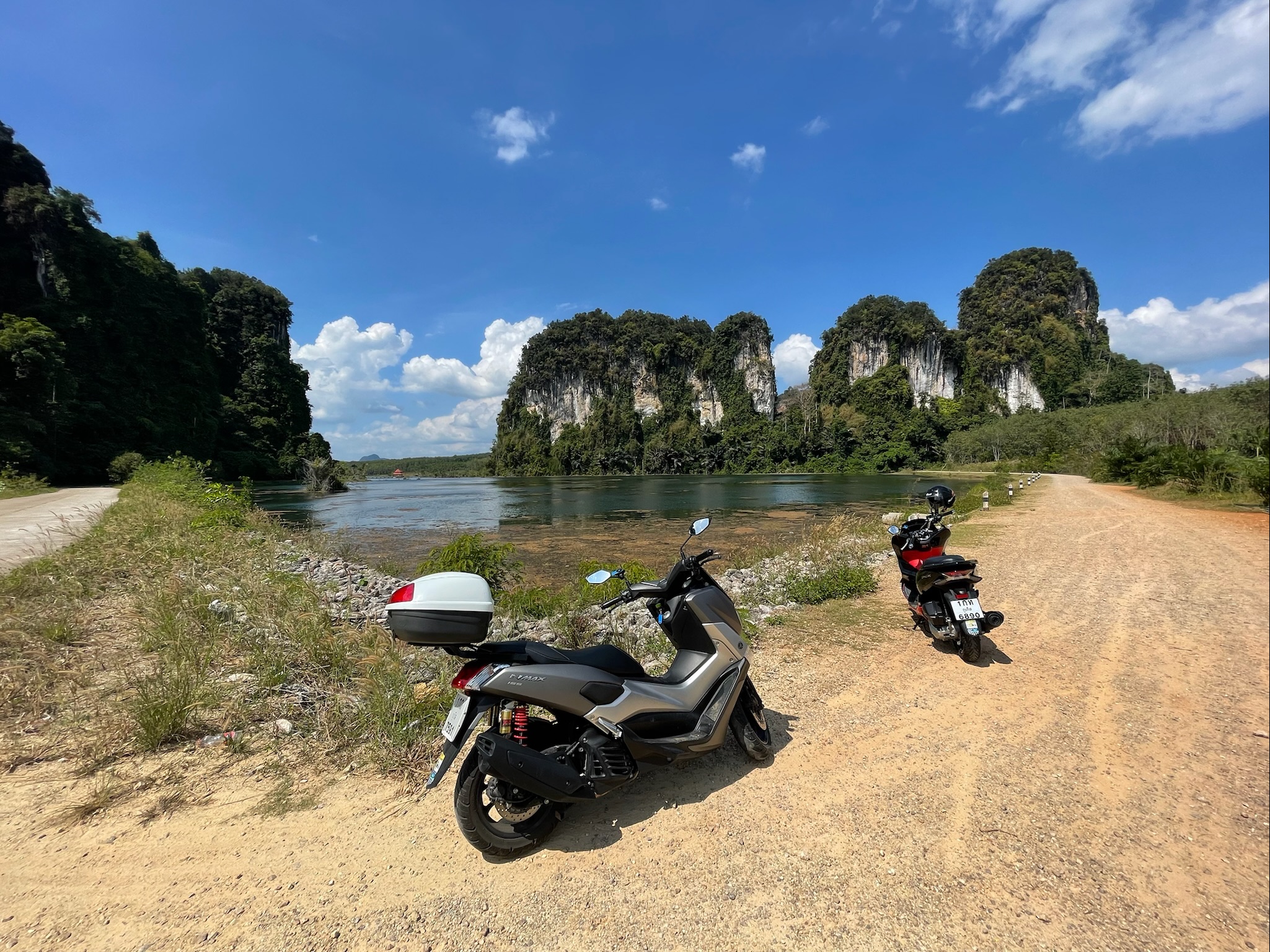 Motorbikes in Krabi, Thailand. Limestone mountains in background