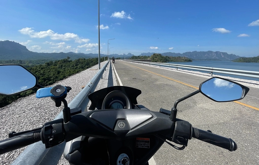 Motorbike riders on a bridge near Khao Sok National Park, Thailand.