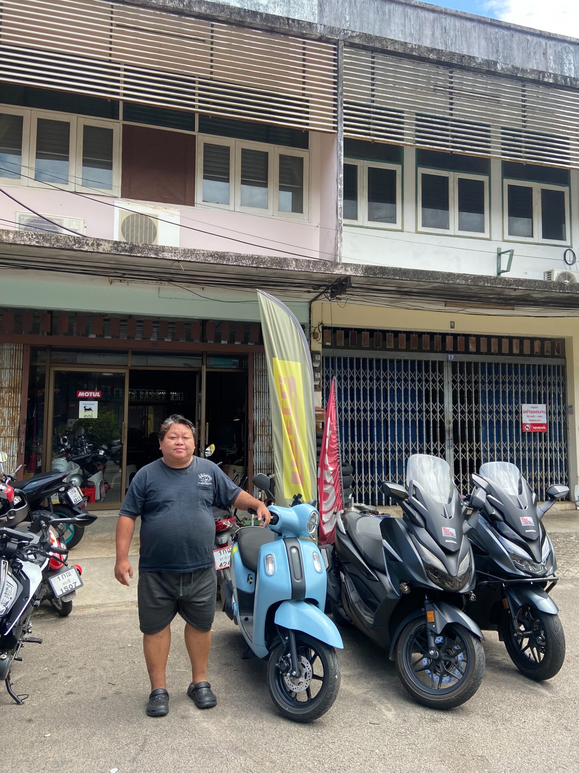 Bigbike Cafe Krabi Joins Byklo: Your Go-To Motorbike Rental in Krabi Town Bigbike Cafe Krabi. Owner standing outside motorbike rental shop in Krabi Town, Krabi. Byklo staff taking picture