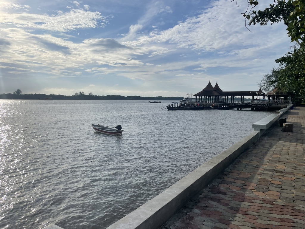 Best coffee shops in Krabi with stunning views Café at the pier in Krabi town. Boats and pier on calm water in the morning