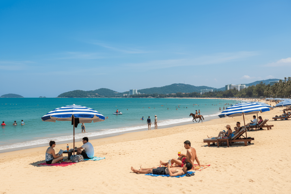 Tourists enjoying sunny day at Hua Hin Beach, Thailand with crystal-clear water