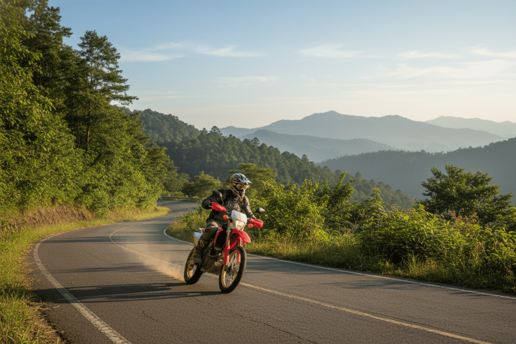 Motorcyclist riding a Honda CRF on a mountain road in Northern Thailand.
